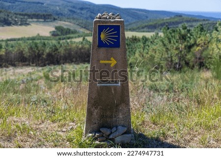 Way marker sign, that guides the pilgrims along the Camino de Santiago in Galicia, Spain. It's written "Galicia" and shows how many kilometers to Finisterra (Fisterra), in the coast of Spain.