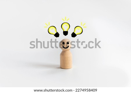 Wooden doll people standing with light bulb icon idea, intelligent think power, creative and idea concept.
