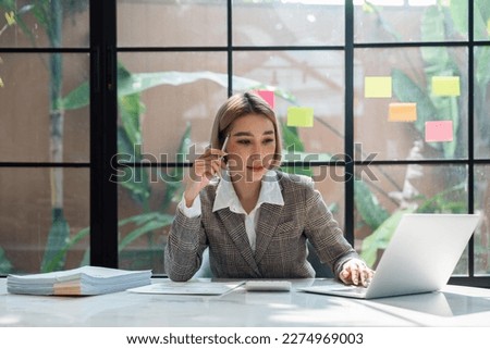 Image of woman thinking and down working sitting at table at office