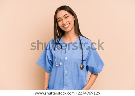 Young nurse colombian woman isolated happy, smiling and cheerful.