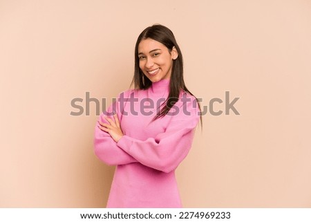 Young colombian woman isolated on beige background happy, smiling and cheerful. Royalty-Free Stock Photo #2274969233