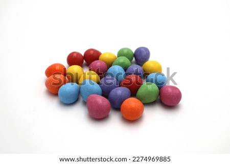 Colorful little milk chocolates Easter holiday eggs with no brand on white isolated background