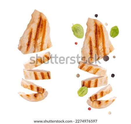 Levitation grilled chicken breast isolated on white background. Grilled chicken slices with pepper mix peas and fresh basil leaves. flying food Royalty-Free Stock Photo #2274976597