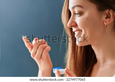 Young woman using soft contact lenses instead of glasses                      Royalty-Free Stock Photo #2274977065