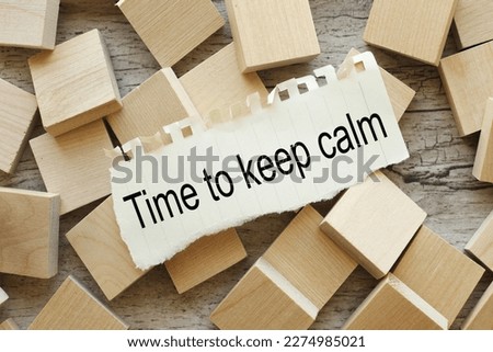 Time to Keep Calm. text on torn paper on wooden cubes.