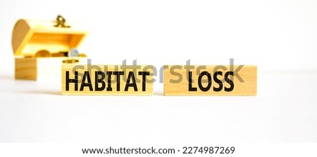 Habitat loss symbol. Concept words Habitat loss on wooden block. Beautiful white table white background. Beautiful wooden chest with coins. Business habitat loss concept. Copy space.
