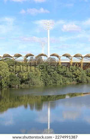 Heritage bank stadium, the home ground of the Gold Coast Suns AFL team with the Nerang river in the foreground, Gold Coast, Australia.  Royalty-Free Stock Photo #2274991387