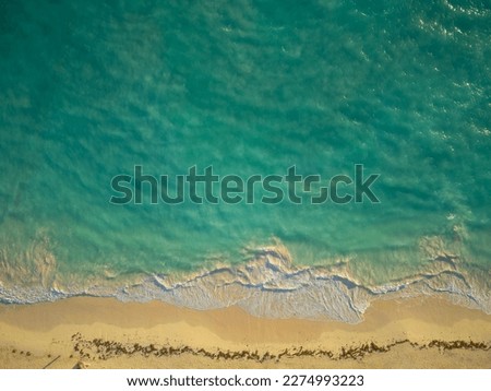 Top view of the sea and sandy shore. Beautiful turquoise water and white sandy beach. Resort place, vacation, vacation, travel, tourism, ecology, environmental protection. Abstraction.