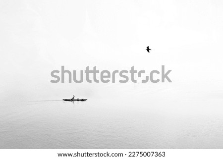 Human life is also river centered. Rivers and people should live in harmony in this country. The picture shows a boatman carrying goods in his boat, free birds fluttering their wings in the sky. 