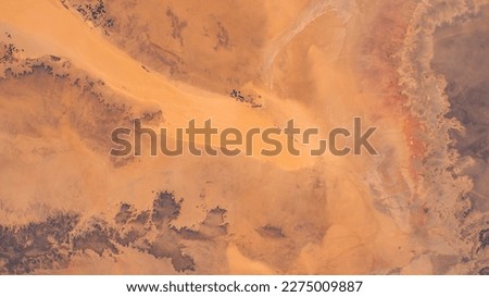 Sahara Desert in Algeria aerial view. Earth landscape. Selective focus included. Elements of this image furnished by NASA. Royalty-Free Stock Photo #2275009887