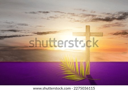 Cross and palm leaf with sunset scene background. Palm Sunday Concept