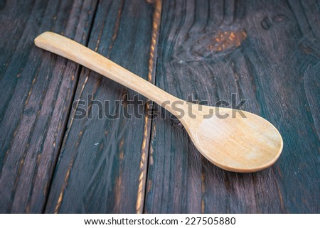 Wooden spoon on wooden background - old style picture process