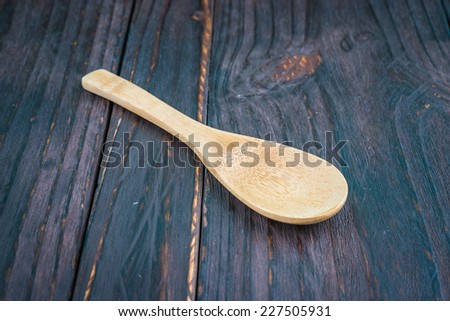 Wooden spoon on wooden background - old style picture process