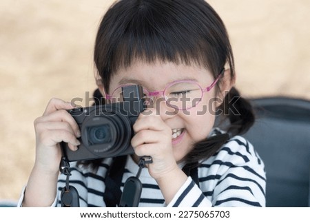 Smiling Asian kid on camera