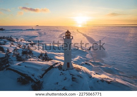 Snowy aerial drone view of Povorotny lighthouse, Vikhrevoi island, Gulf of Finland, Vyborg bay, Leningrad oblast, Russia, winter sunny day with blue sky, lighthouses of Russia travel Royalty-Free Stock Photo #2275065771