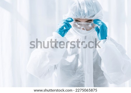 Male doctor in protective medical uniform in clinic