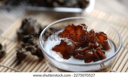 Auricularia polytricha or Cloud ear mushroom, dry and soaked in water in a bowl. Bakji mushroom. Royalty-Free Stock Photo #2275070527