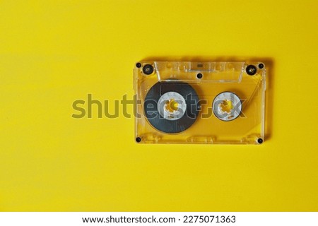 audio cassette for recording music on a yellow background