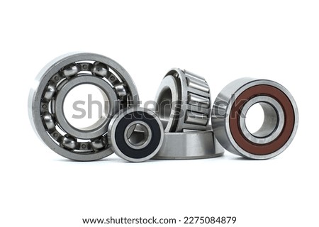 Various ball bearings and tapered roller bearing isolated on white background. Spare parts for machinery and automotive industry Royalty-Free Stock Photo #2275084879