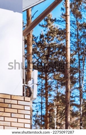 Antenna for cellular communication against the blue sky on the roof of a countr house. vertical. High quality photo