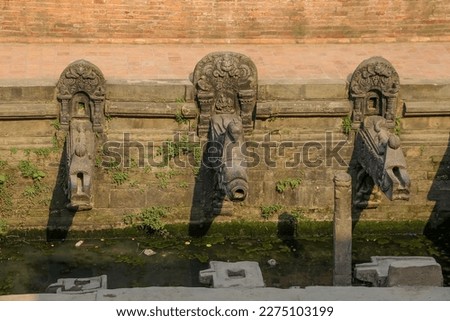 Manga Hiti (Dhunge Dhara) stone water spouts (traditional nepalese drinking fountain) on Patan Durbar Square in  Lalitpur city, Nepal. Soft focus. Architecture feature theme.