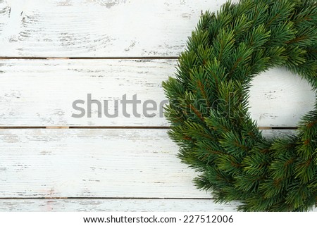 Decorative Christmas wreath on wooden background
