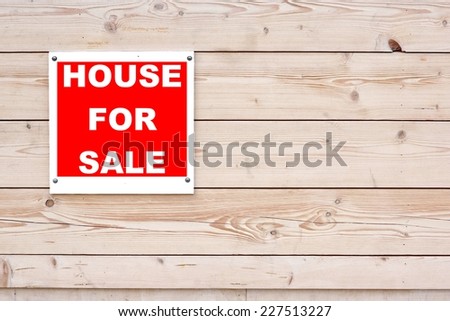 HOUSE FOR SALE Red White Sign on Timber Wall Background