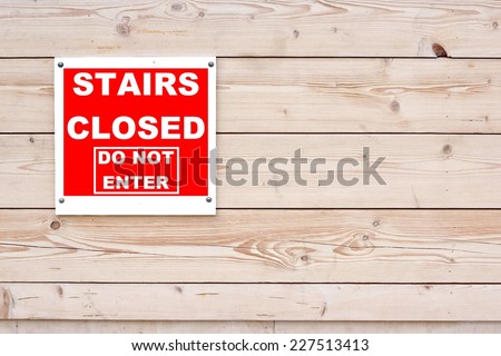 STAIRS CLOSED DO NOT ENTER Red White Sign on Timber Wall Background