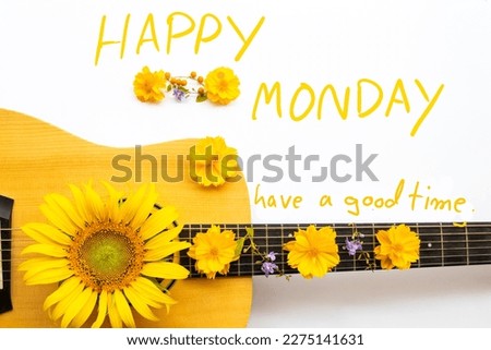 happy monday have a good time message card handwriting with yellow flower and guitar arrangement hearts flat lay postcard style on background white
