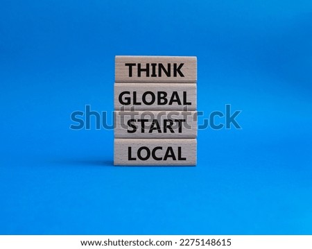 Think global act local symbol. Wooden blocks with words Think global act local. Beautiful blue background. Business and Think global act local concept. Copy space.