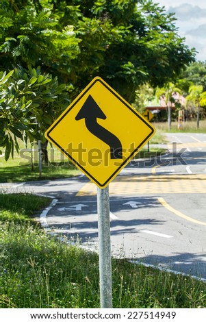 Road Sign Warning of Dangerous Curve Ahead
