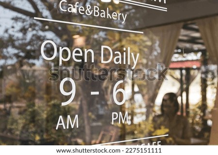 Text white vintage  "Open Daily "  in a cafe.