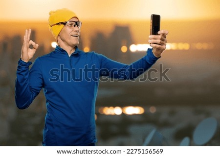 Portrait of active healthy male runner taking selfie on urban background, generative AI