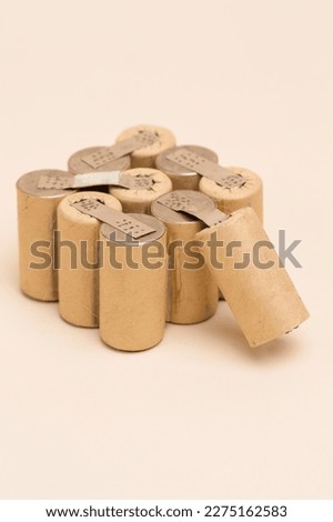 Energy and Environment Ideas. Bundle of Soldered Ni-Mh Rechargeable Batteries  Placed Together Over Beige.Vertical image Royalty-Free Stock Photo #2275162583