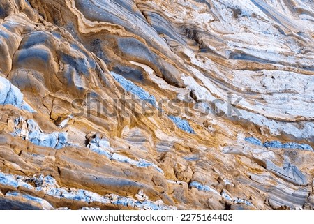 Mesmerizing abstract natural background composed of layered rocks with intricate patterns and textures. Royalty-Free Stock Photo #2275164403
