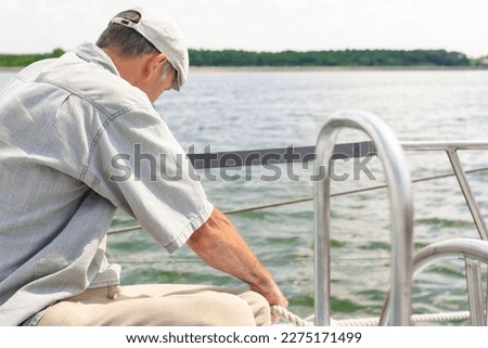 Closeup up of Yachtsman Hands Dealing with Yacht Rope. Horizontal Image Royalty-Free Stock Photo #2275171499