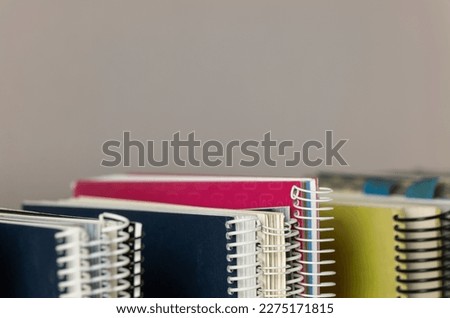 Still life of spiral notebooks against grey background