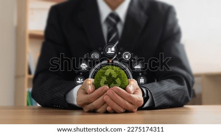 Businessmen holding the green ball that have recycle symbol with zero waste icons. Concept for save world, Sustainable business development, business responsible environmental, social and governance.