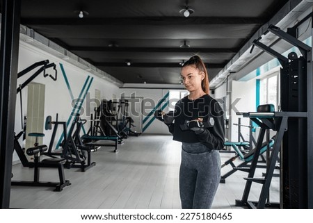 close-up young woman trains muscles on exercise machine in the gym. sport concept. fitness way of life and people.