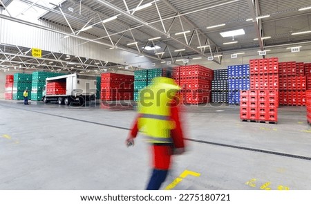 loading of beer crates for trade in a brewery - forklift trucks and trucks in the industrial hall - department store  Royalty-Free Stock Photo #2275180721