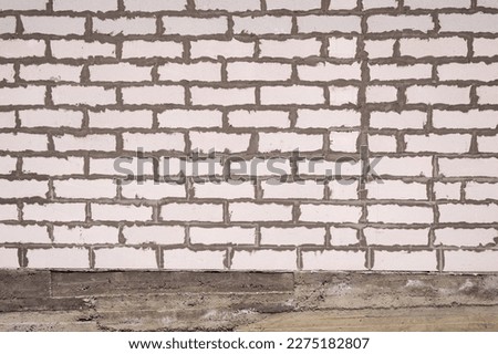White bricks facade wall without plaster. Empty background of stained brickwork construction