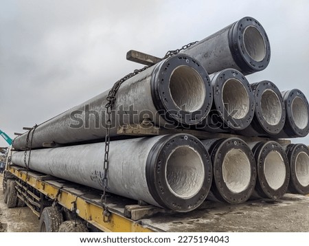 the pile or spun pile is transported by truck to the construction site Royalty-Free Stock Photo #2275194043