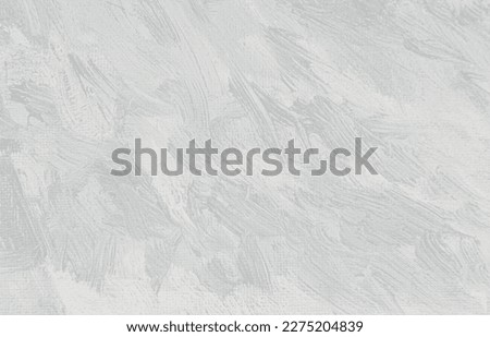 Modern art concept. An artists palette with light gray shades of paint. Abstract grey background. Close up of mixed brush strokes.