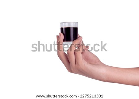Hand-hold mini glass cup of americano coffee isolated on a white background. Royalty-Free Stock Photo #2275213501