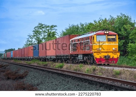 Container-freight train by diesel locomotive on the railway. Royalty-Free Stock Photo #2275220783
