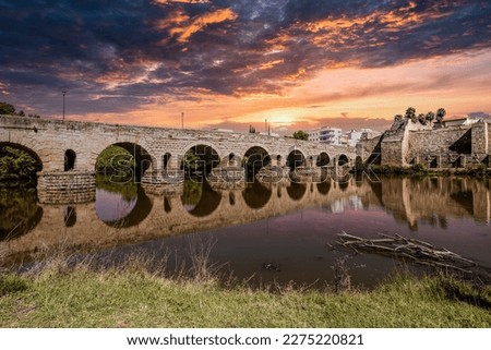 Historical Bridge, built by the Romans. It is the longest surviving Roman bridge, over the Guadiana River in Merida, Extremadura, Spain. Puente Romano is the Spanish name for the Roman Bridge. Royalty-Free Stock Photo #2275220821