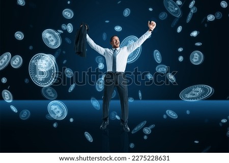 Financial freedom, success, investing and cryptocurrency concept with happy businessman on dark blue background under bitcoin rain Royalty-Free Stock Photo #2275228631