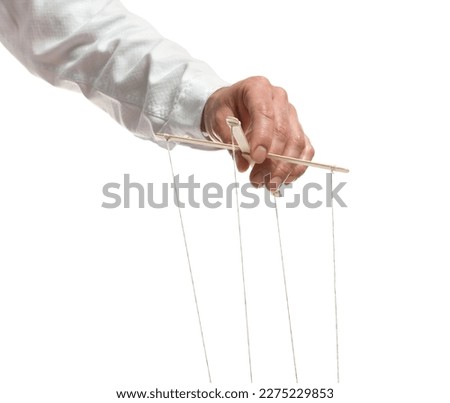 Man pulling strings of puppet on white background, closeup Royalty-Free Stock Photo #2275229853