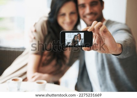 Preserving loving memories. an attractive young couple snapping pictures of themselves.