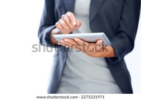 Doing business the modern way. A cropped image of a businesswoman working on a digital tablet.